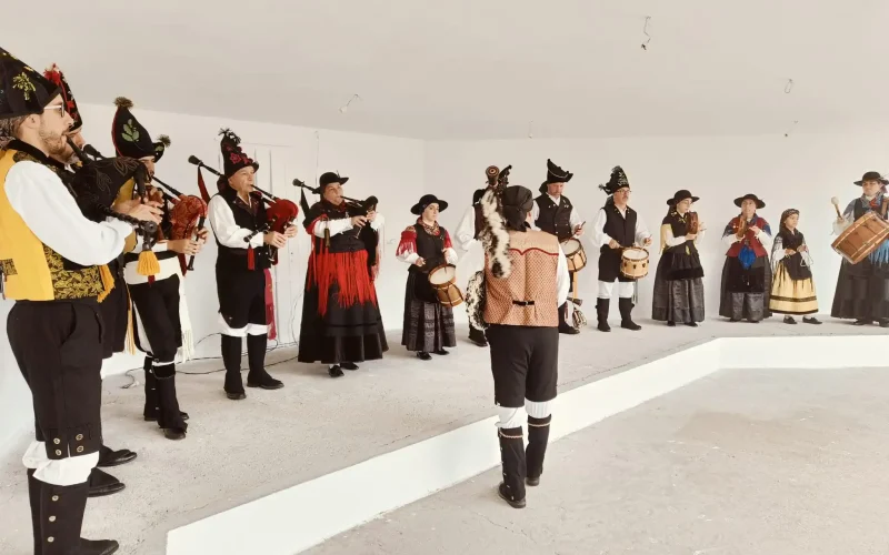 Concerto de música tradicional galega con gaitas e percusión no campo da feira.
